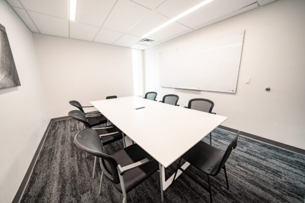 study room with desk, chairs, TV, & whiteboard